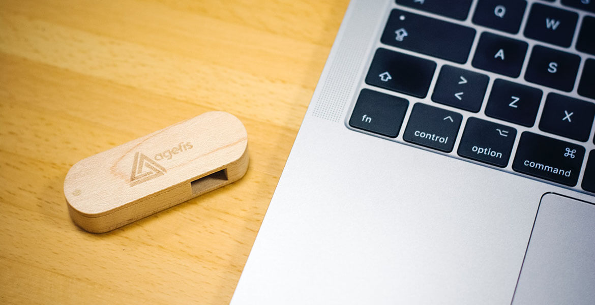 brown thumb drive beside MacBook