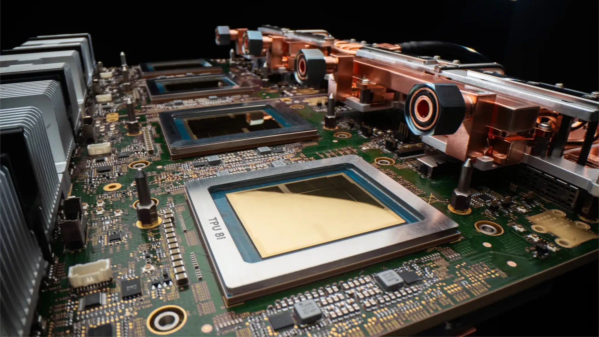 Close up of a computer motherboard showing a CPU socket and a copper heat pipe cooling assembly