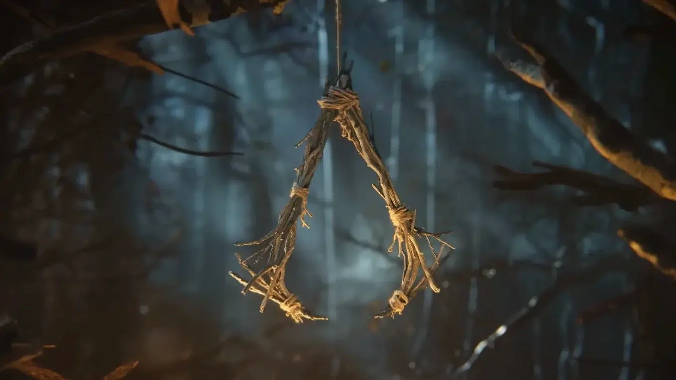 Twig noose hanging from a branch in a dark misty forest creating a eerie ominous mood