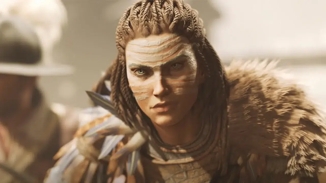 Person in tribal war paint and feathered armor looking intently at the camera in a warrior costume