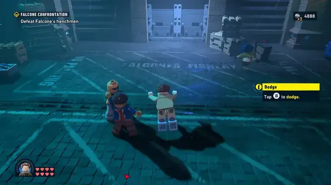 Первая волна врагов Lego style characters in a blue lit warehousedock area with Falcone confrontation objective text about to dodge on screen Dodge prompt
