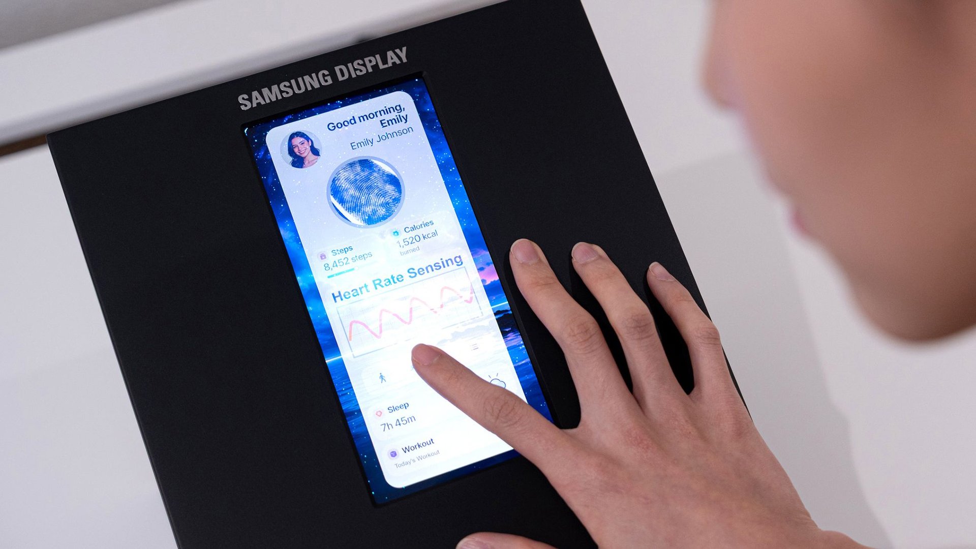Close up of a person using a Samsung display touch panel showing a health app with heart rate and steps