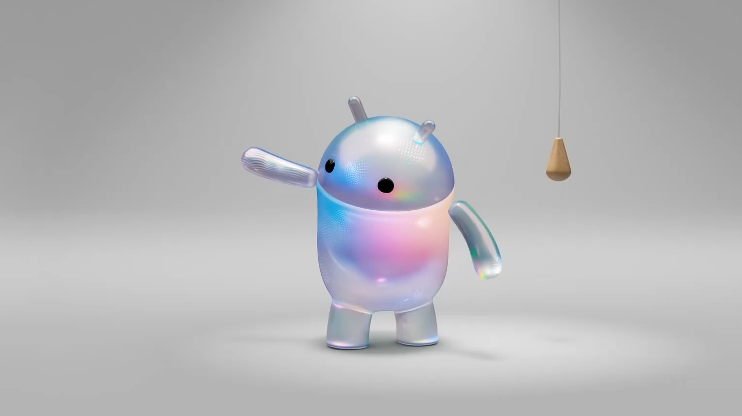 Iridescent jelly like cartoon robot with two antennae and black eyes raising its left arm in a bright studio setting