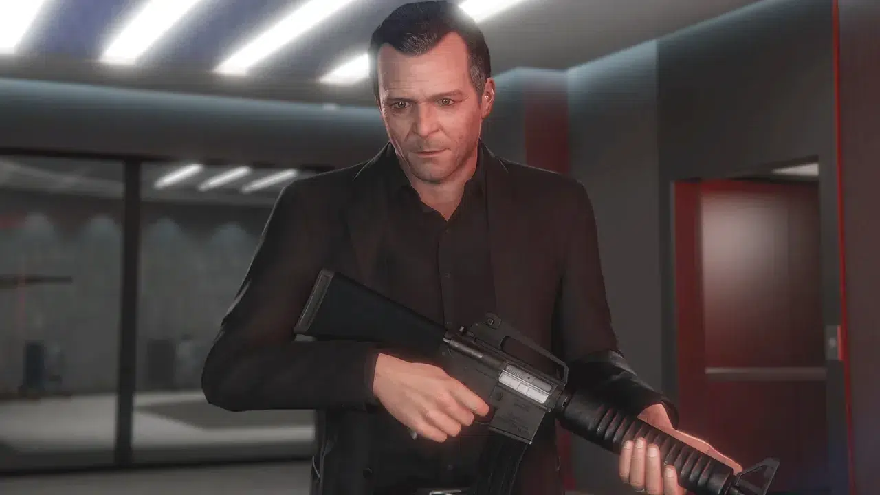 Man in a black suit holds a rifle indoors looking ahead