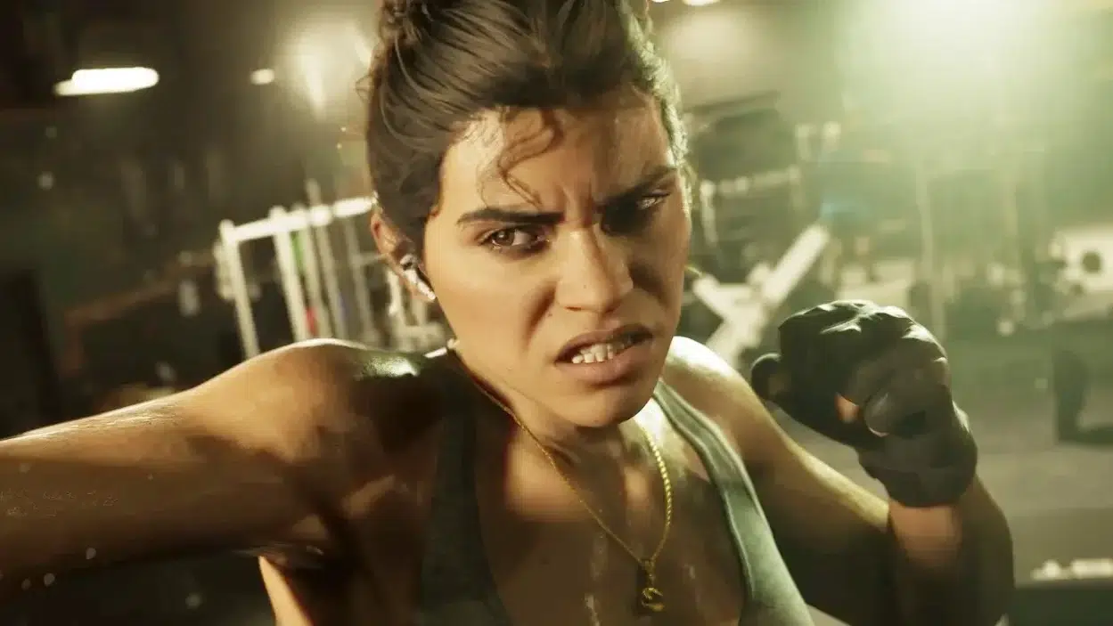 Female athlete in workout gloves throws a punch in a gym focused expression