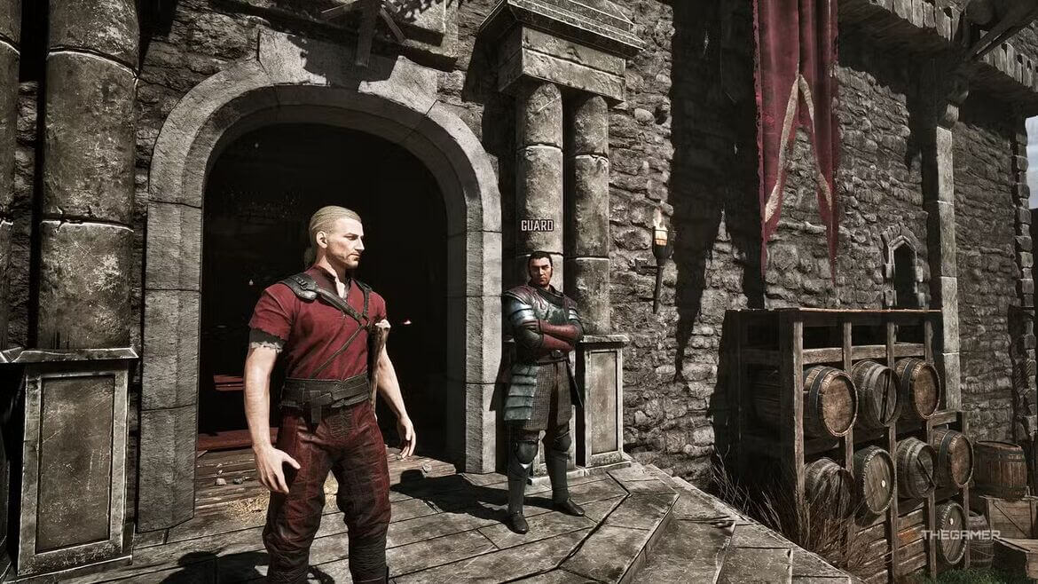 Two armored guards stand outside a stone fortress doorway with barrels on the right and a red banner nearby