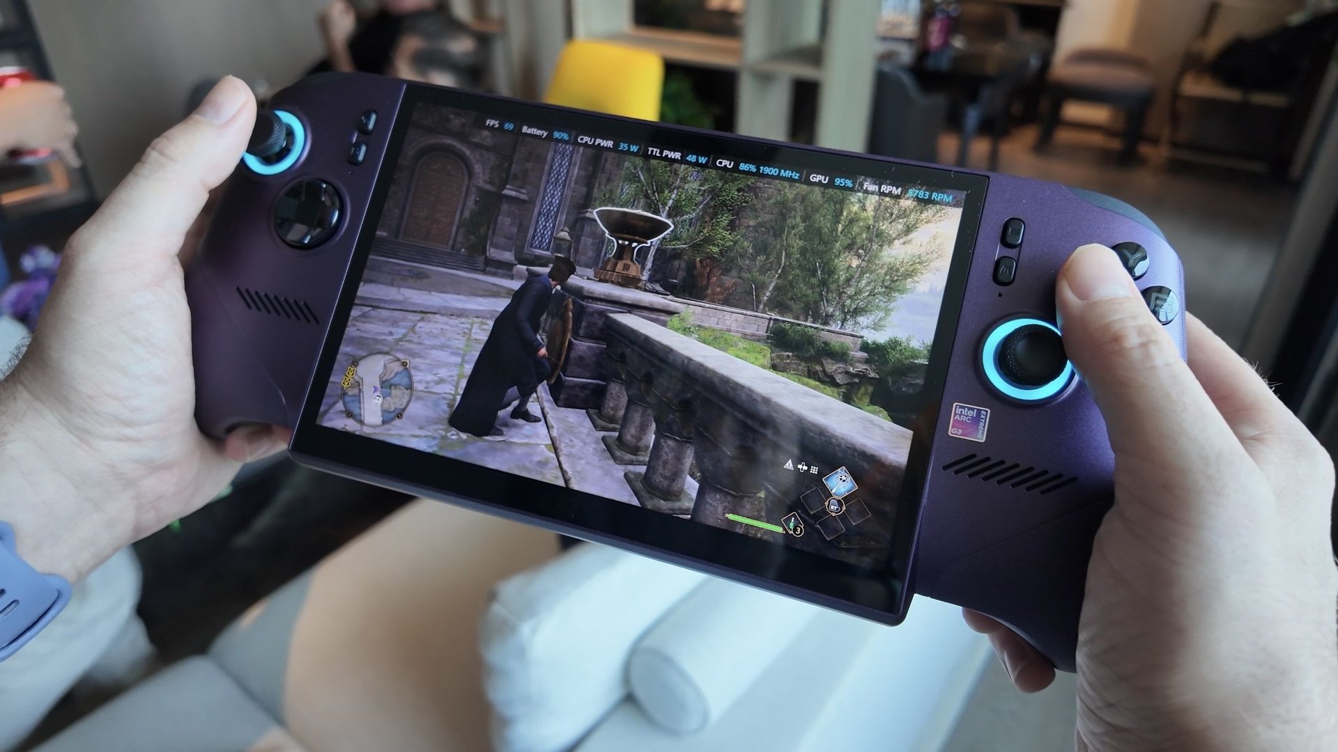 Person playing a fantasy action RPG on a purple handheld console with glowing blue joysticks