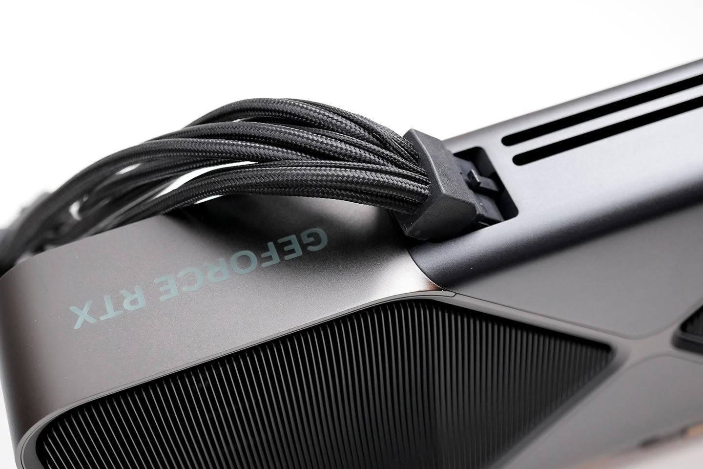 Close up of a GeForce RTX graphics card with braided power cables attached