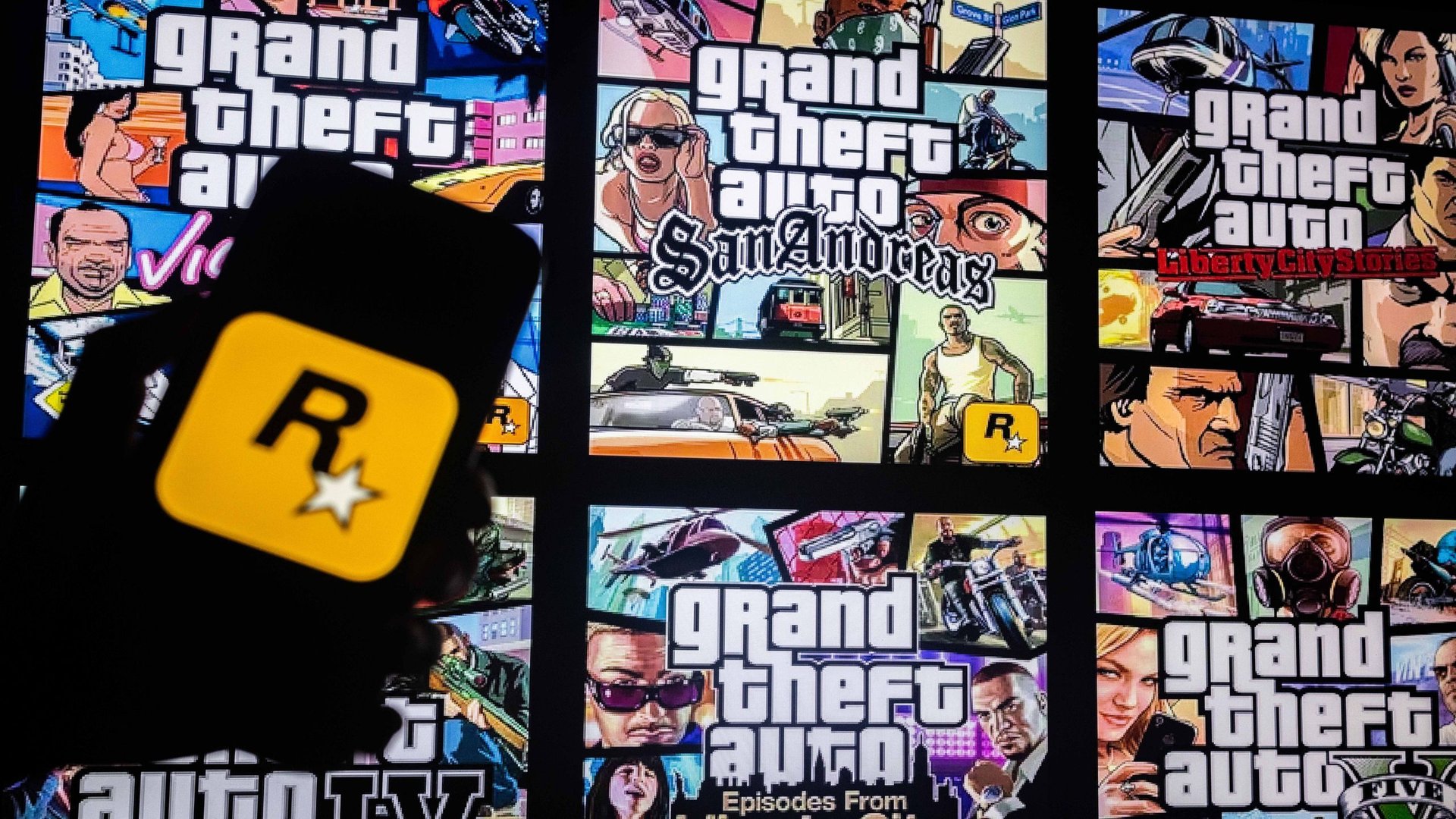 Collage of Grand Theft Auto game cover panels in bright colors with a silhouetted figure holding a yellow Rockstar badge in the foreground