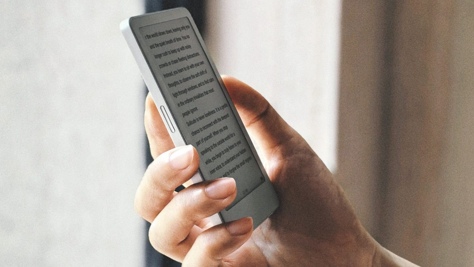 A close up of a hand holding a smartphone with text displayed on the screen as if reading