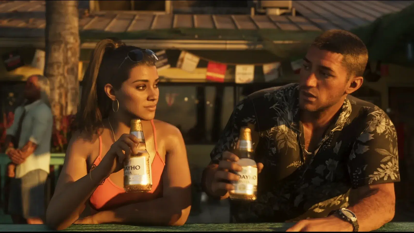 Two friends sit at a sunlit outdoor bar each holding a bottle of beer and chatting The woman wears a coral bikini top with sunglasses on her head the man wears a black floral shirt Sunset lighting casts warm tones