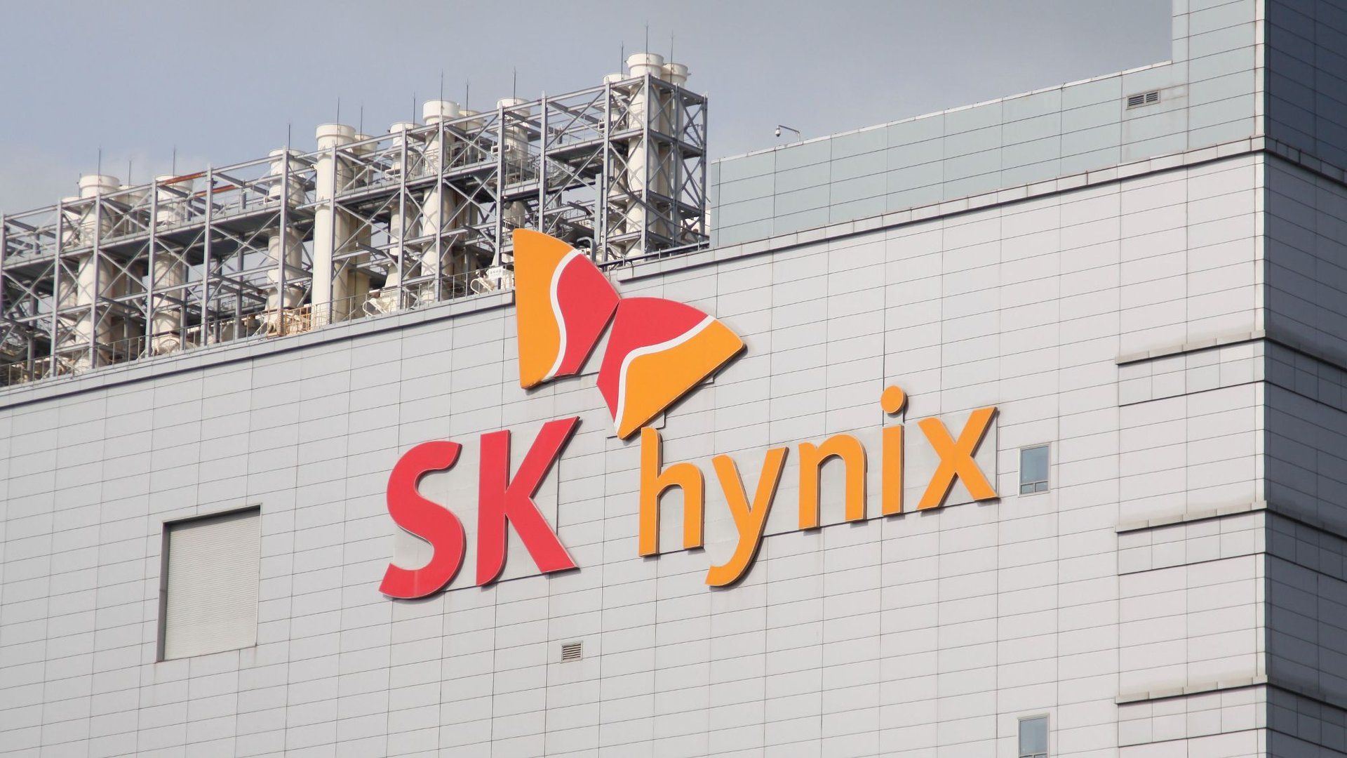 Facade of a white tiled building featuring the orange and red SK hynix logo with a butterfly emblem on the wall