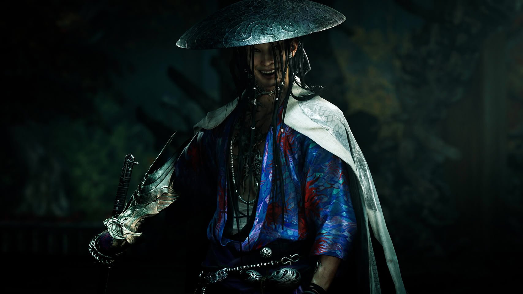 Person in a wide brimmed textured hat and ornate blue red robe holding a sword in a dim forest backdrop