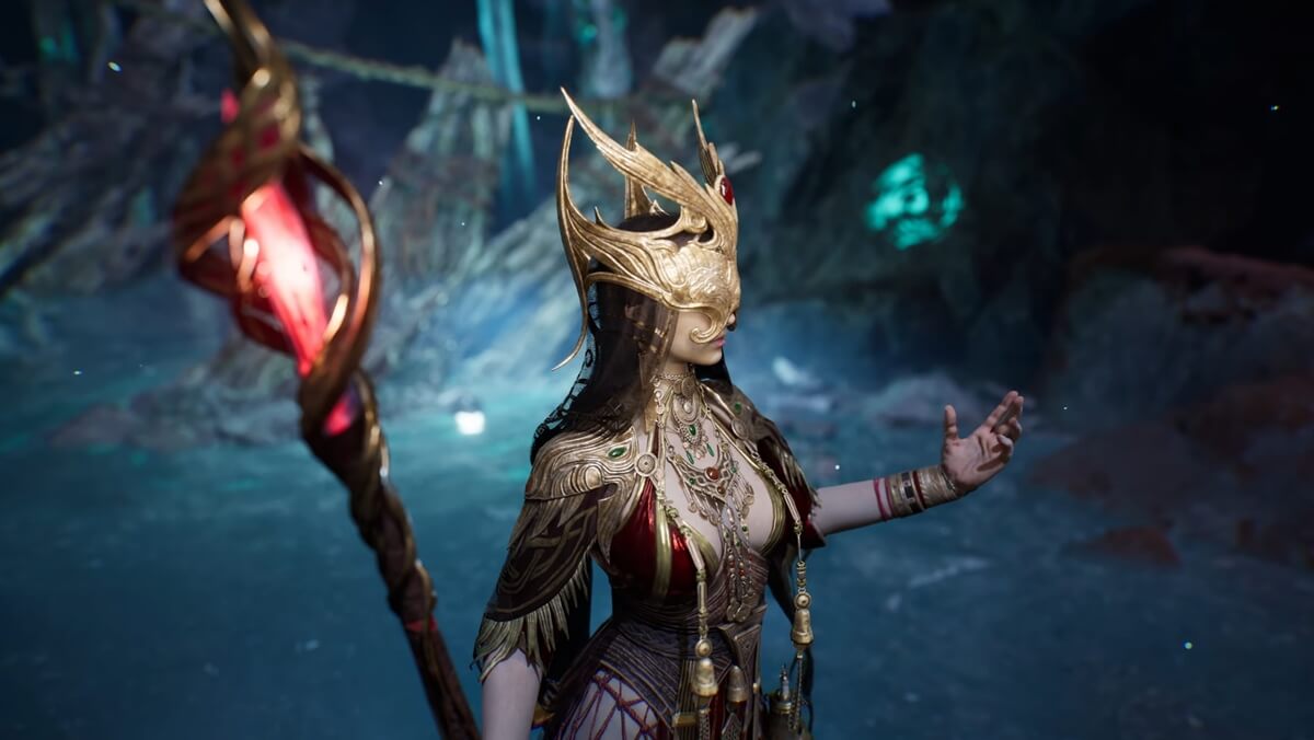 Fantasy warrior woman in an ornate gold headdress and jewelry raising a carved staff with a glowing red gem in a dim cavern